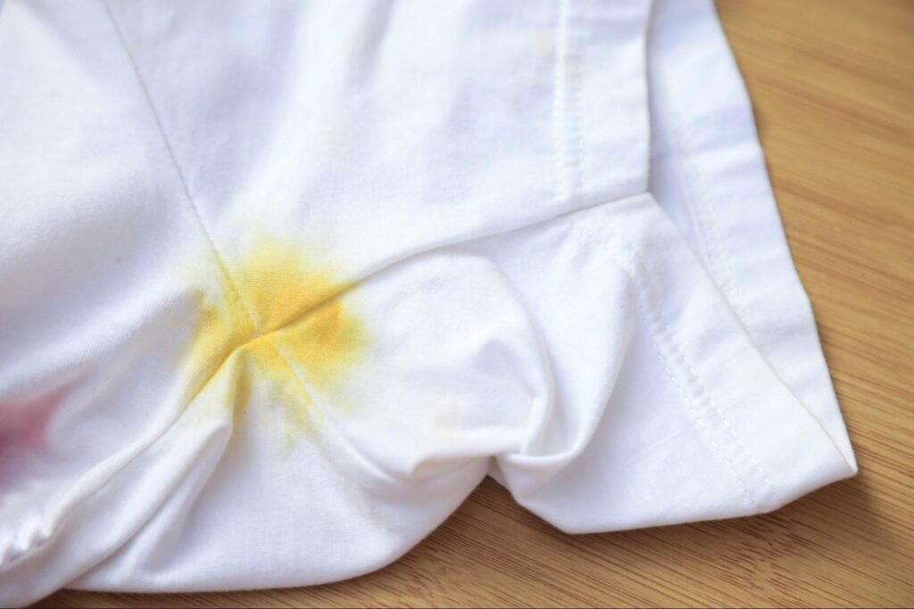 Yellow armpit stains on a white shirt