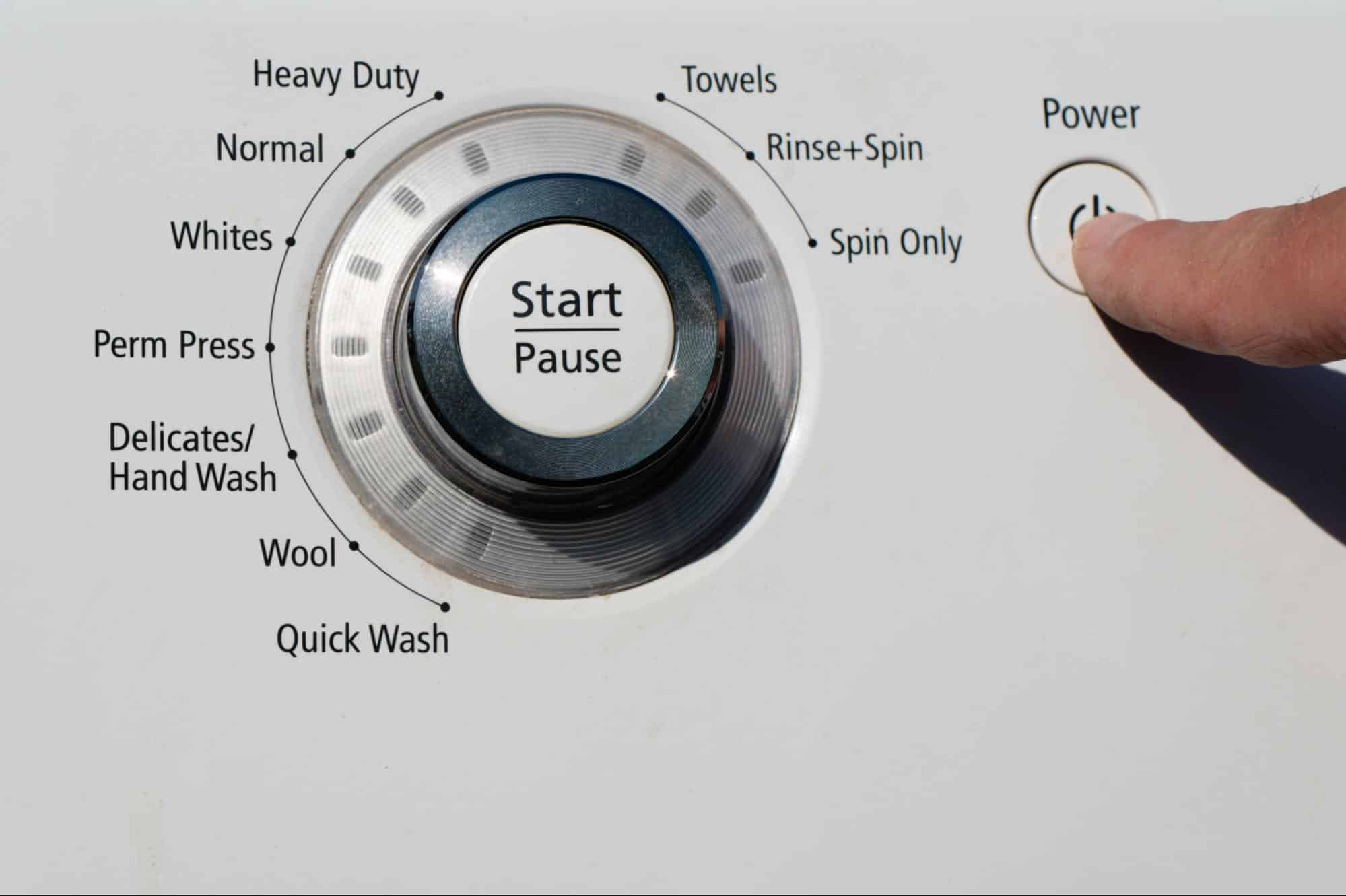 Washing machine control panel close-up with cycle options