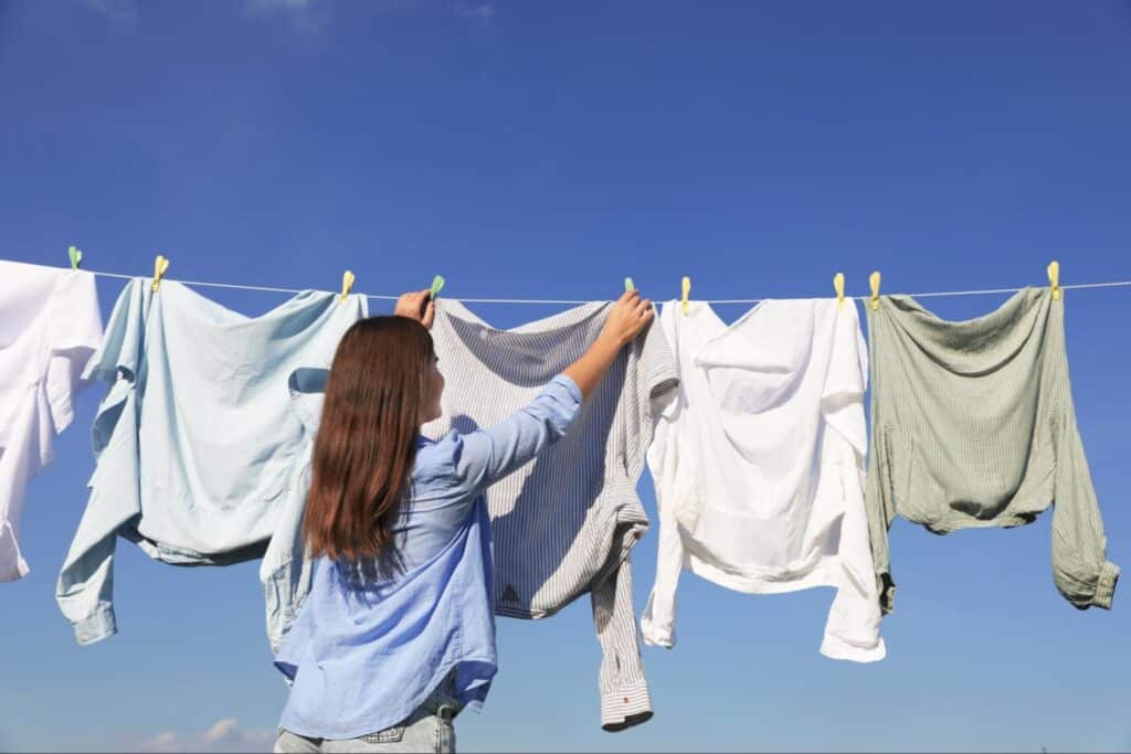 clothes hanging outside on a clothesline to air out and remove odors
