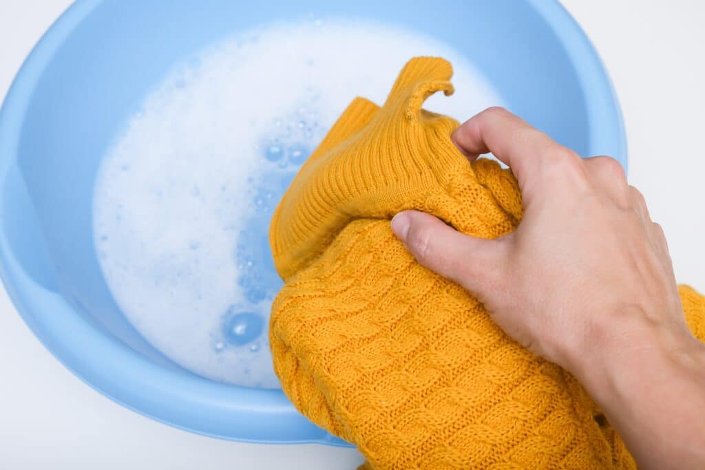 Hand Washing Of Delicate Woolen Knitted Clothes Sweaters Concept