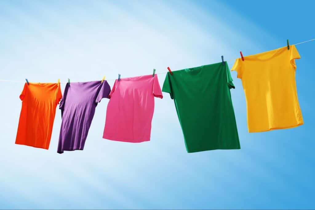 Colorful clothes hanging to air dry on an outdoor laundry line