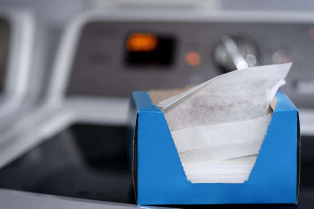 Dryer sheets and wool dryer balls on top of a dryer