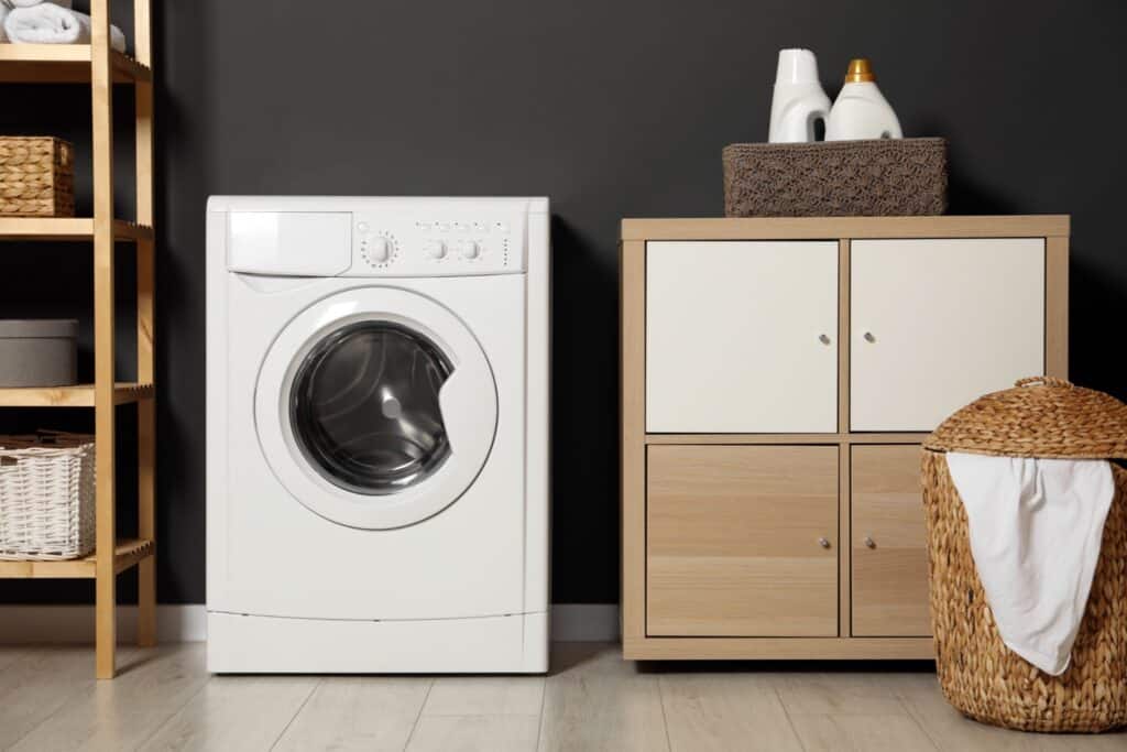 A modern high-efficiency front-load washing machine in a home laundry room