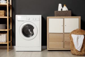A modern high-efficiency front-load washing machine in a home laundry room