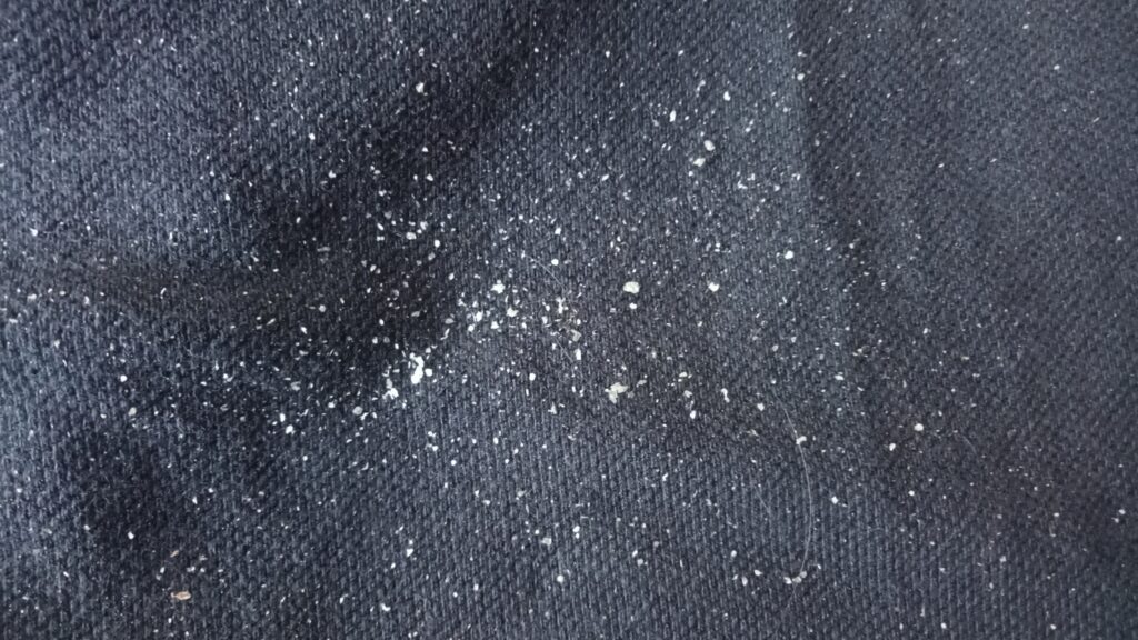 Dark clothing with white detergent streaks after washing