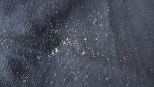Dark clothing with white detergent streaks after washing