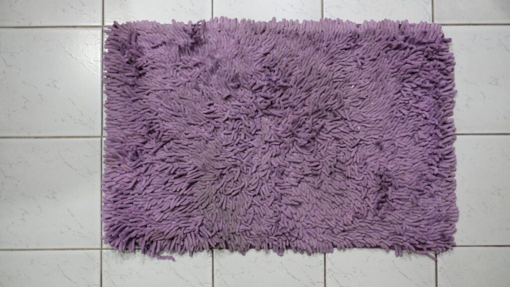 Small rubber-backed bath mats and rugs ready to be washed