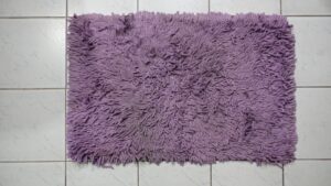 Small rubber-backed bath mats and rugs ready to be washed