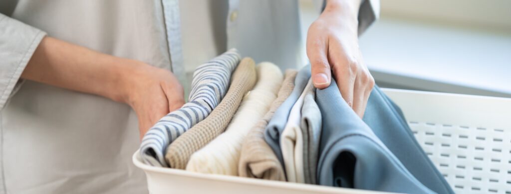 Close-up of a laundry basket filled with fresh, clean folded clothes