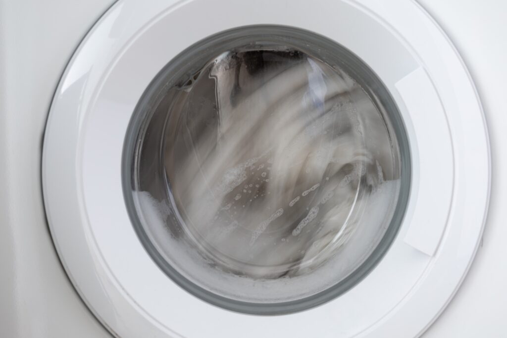 Clothes spinning in a washing machine drum during the high-speed spin cycle