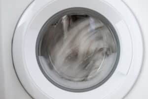 Clothes spinning in a washing machine drum during the high-speed spin cycle
