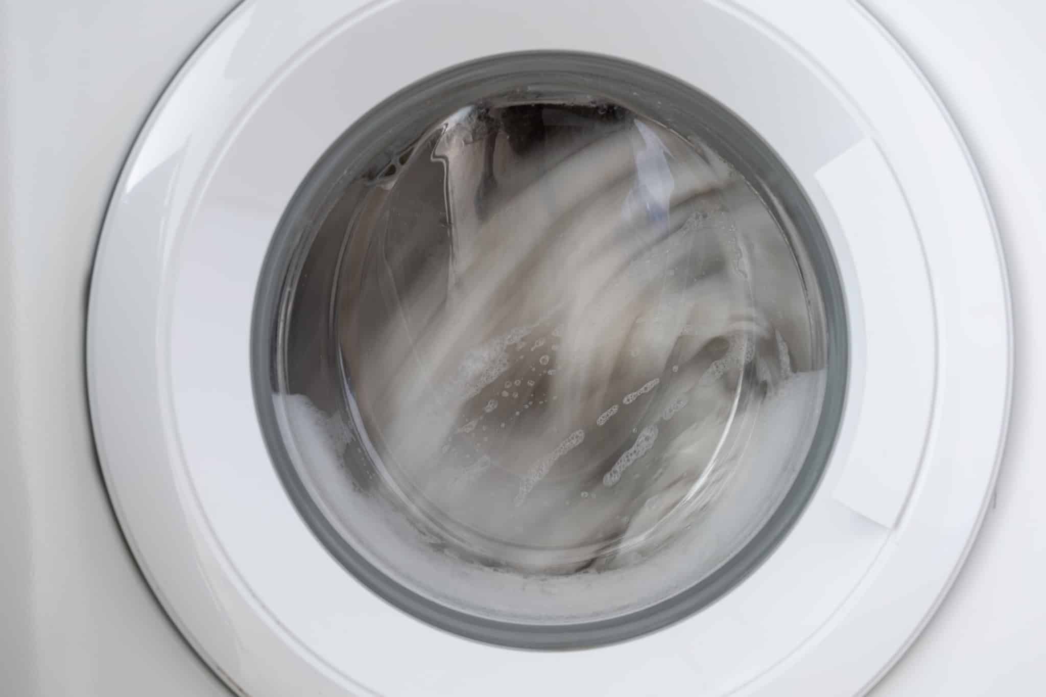 Clothes spinning in a washing machine drum during the high-speed spin cycle