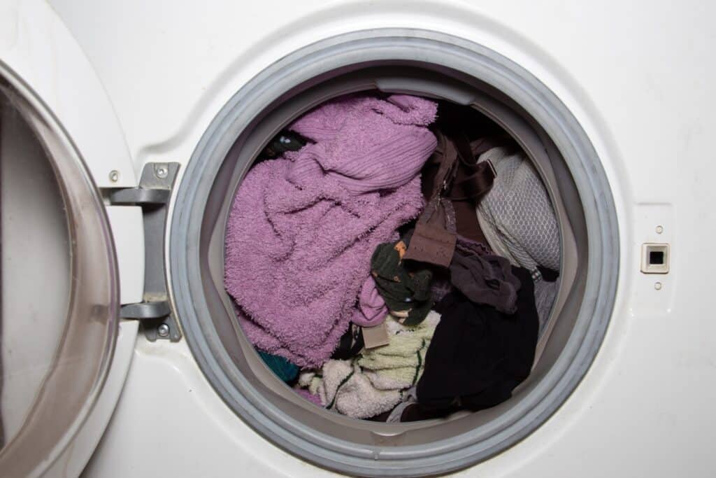An overloaded washing machine drum with too many clothes (a common cause of residue)