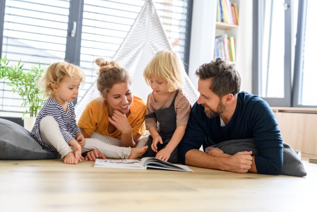 Working parents enjoying playtime with their child instead of doing laundry