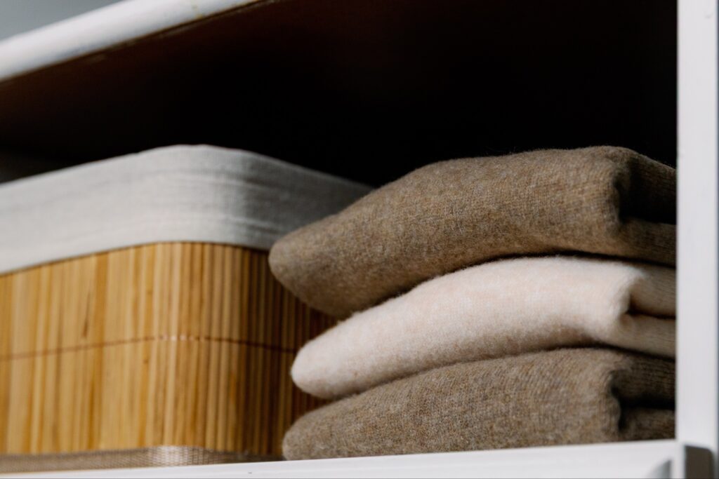folded cashmere sweaters stored neatly with cedar blocks