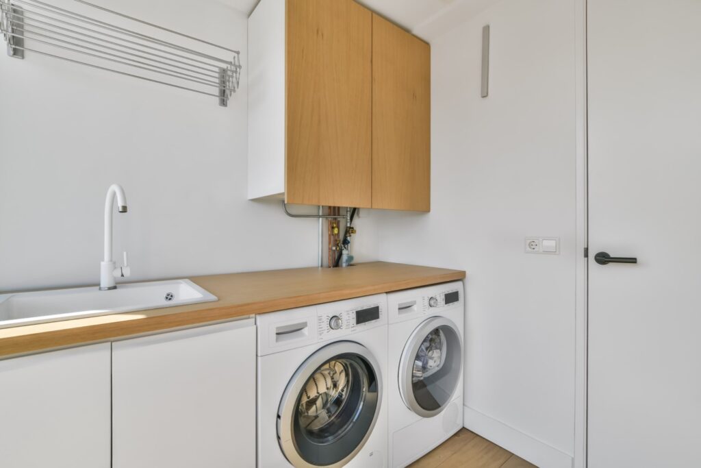 Compact laundry room with countertop and cabinets