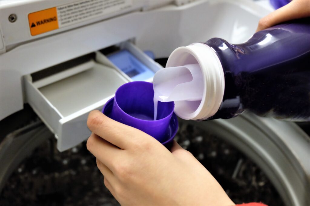 pouring-detergent-into-washing-machine-drawer