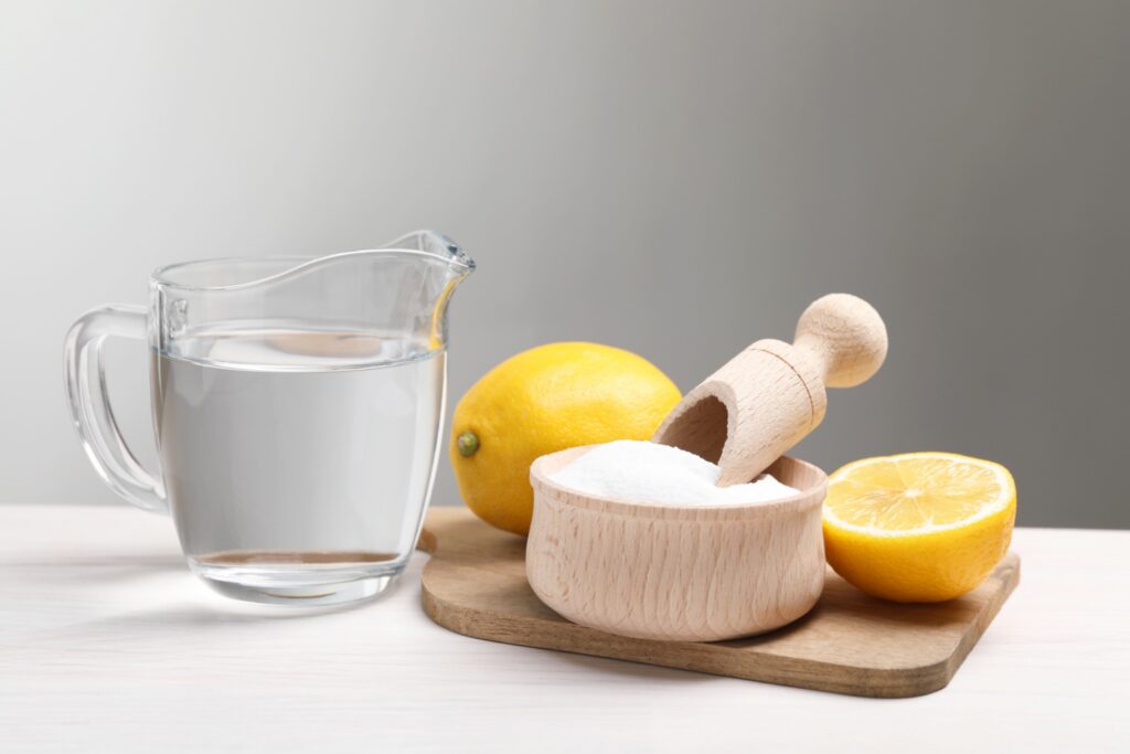 Baking soda vinegar and lemons on a kitchen counter