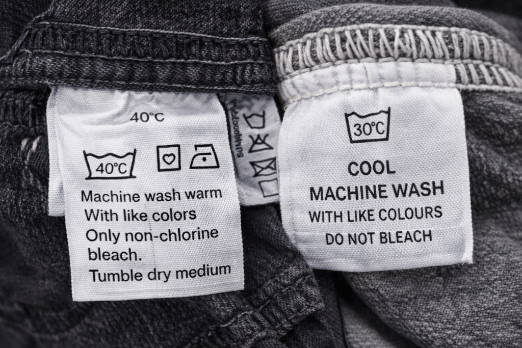 Clothing care labels showing warm wash and cold wash instructions