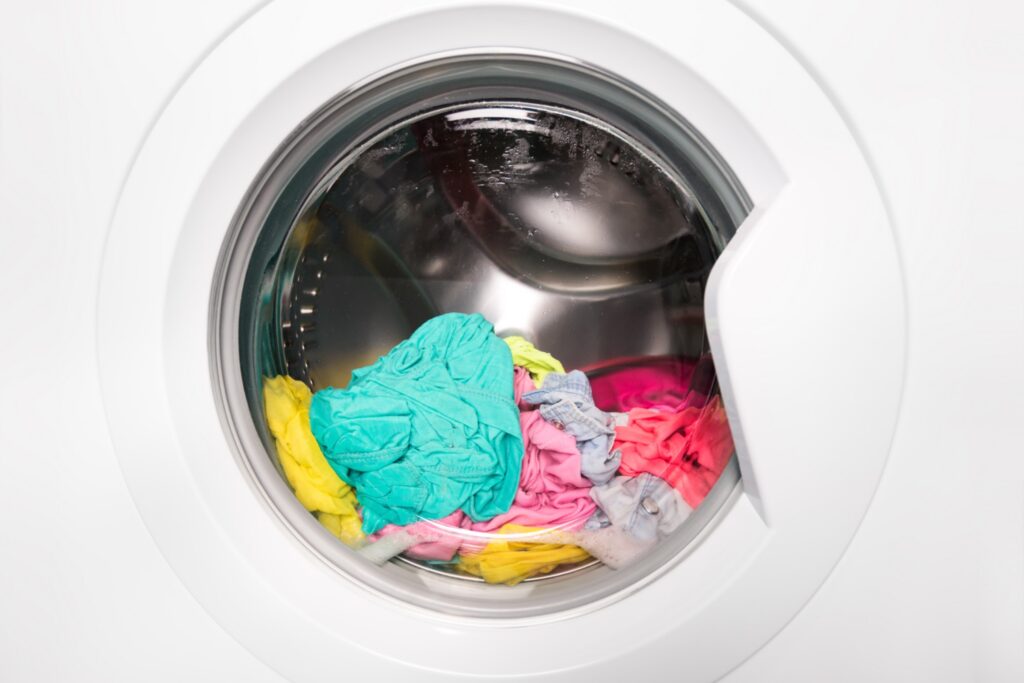 Wet laundry sitting inside a front load washing machine