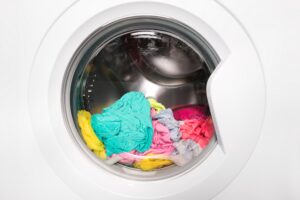 Wet laundry sitting inside a front load washing machine