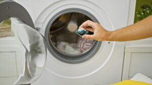 Hand Holding Laundry Detergent Pod