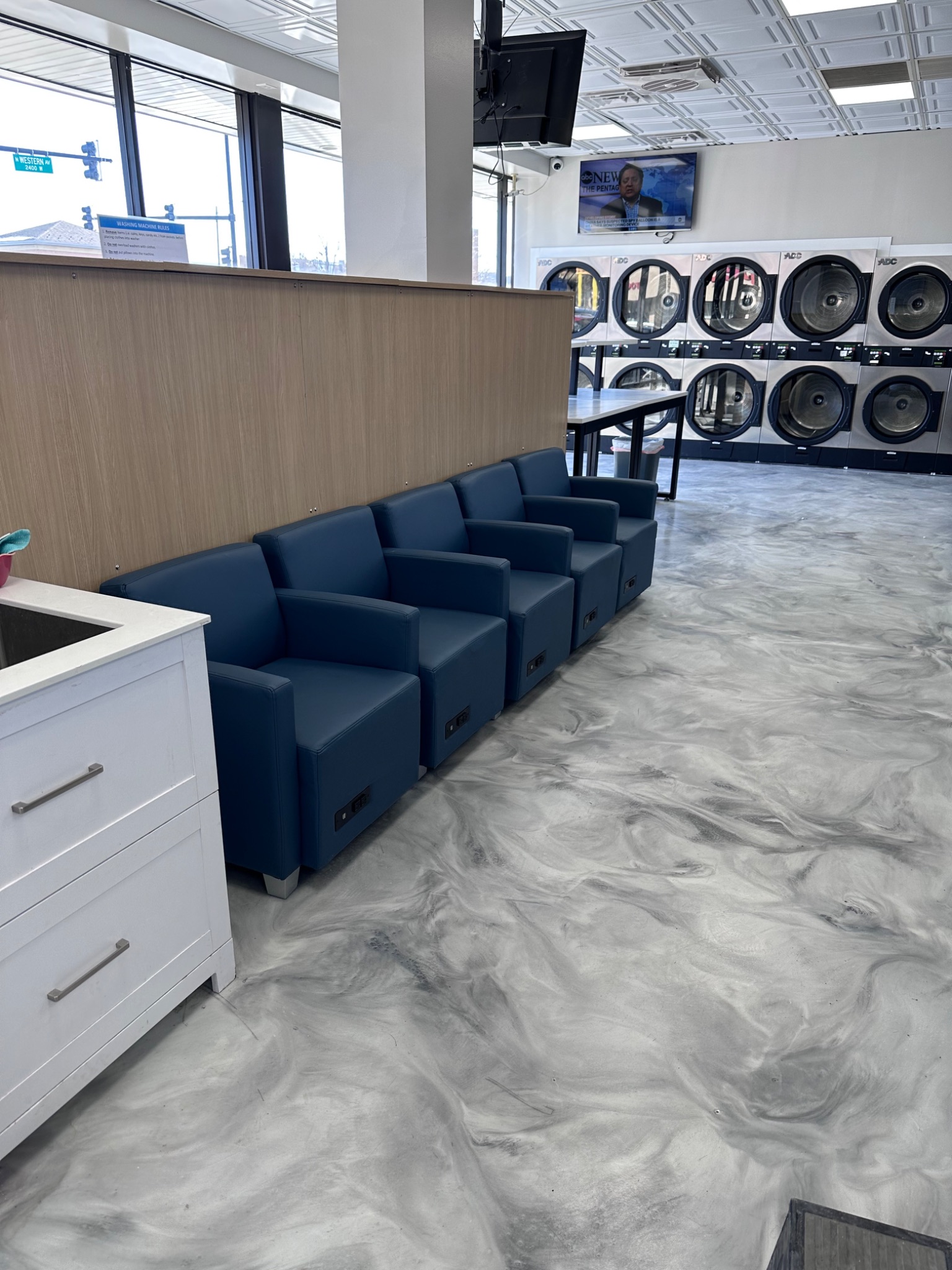 Row of blue chairs in laundromat