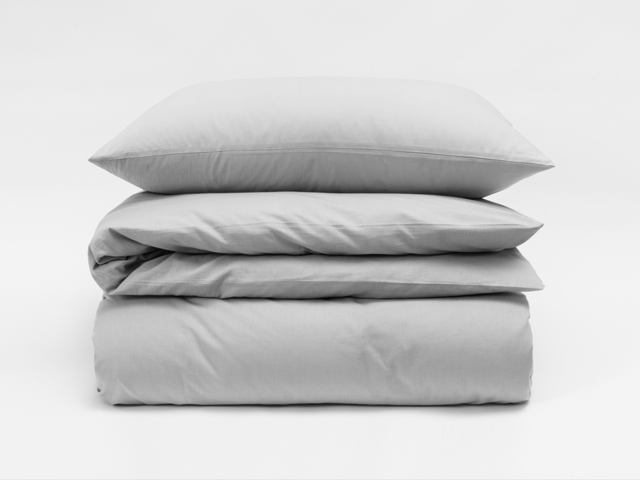Gray pillow and bedding stack
