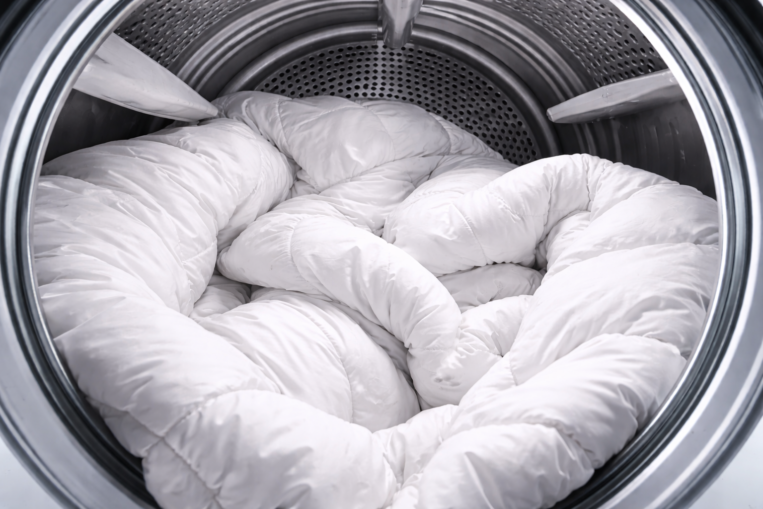 White comforter inside a washing machine